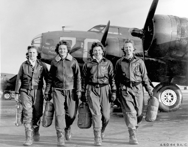 Four women walking away from airplanes