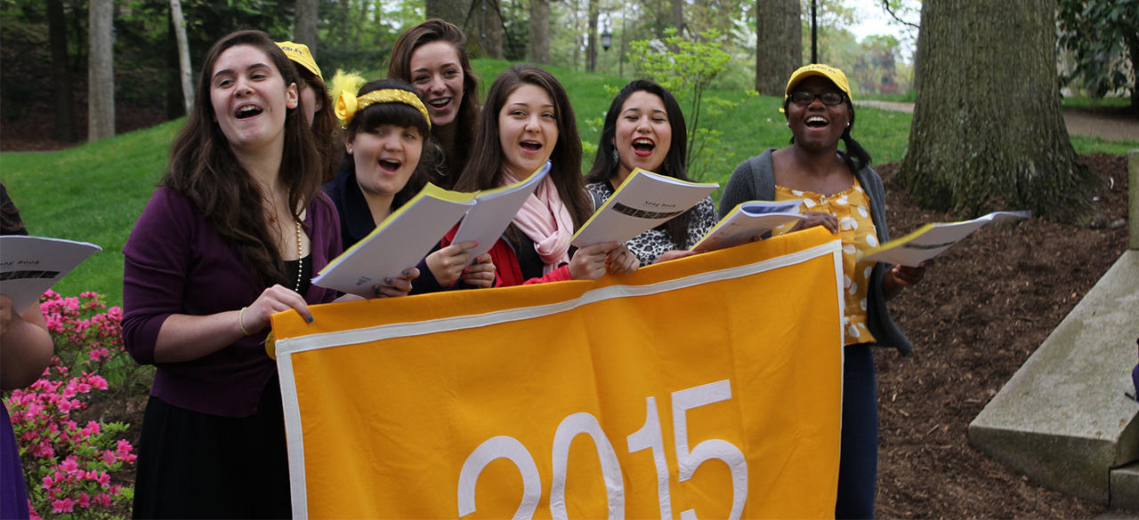 Members of the class of 2015 behind a class banner