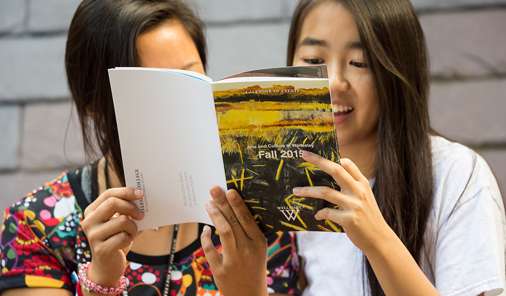 Students read the Fall 2015 Arts Calendar