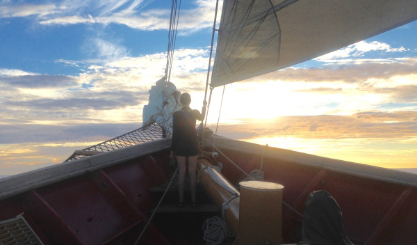 Anthea Fisher ’17 watches the sun set over the Mediterranean Sea from the bow of the SSV Corwith Cramer. 