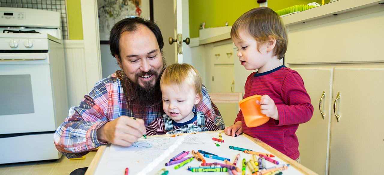 David Teng-Olsen, assistant professor of art, colors with his sons, Jack and Felix.