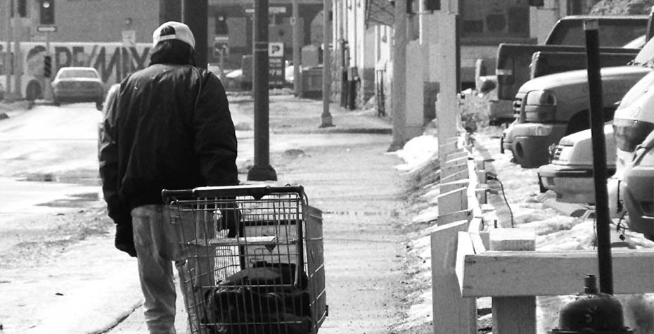 A man pulls a shopping cart in the snow. Changes to government safety-net programs meant more hardships for low-income families during the Great Recession.