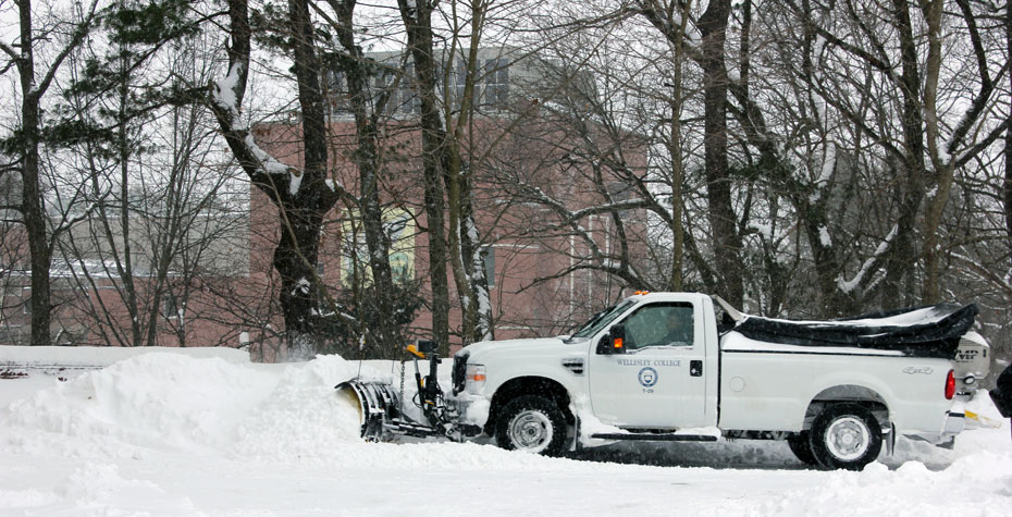 grounds crew plowing snow