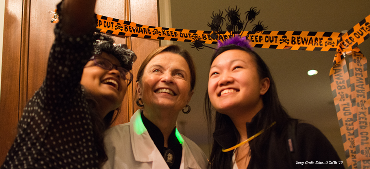 President Bottomly takes a "selfie" with trick or treating students