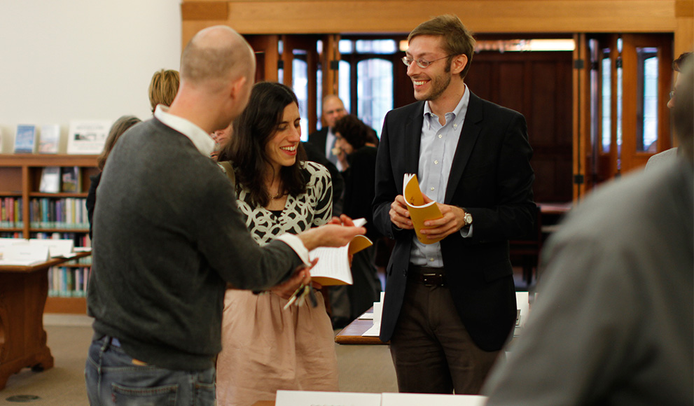 Three faculty members converse at scholarship celebration