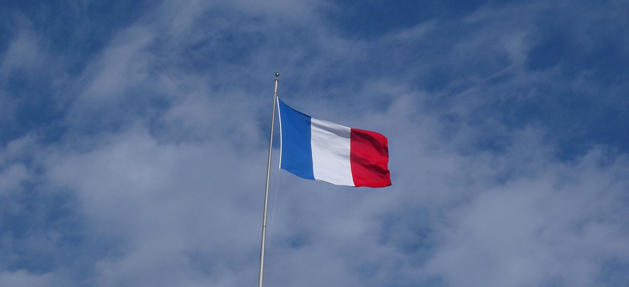 The French flag against blue sky