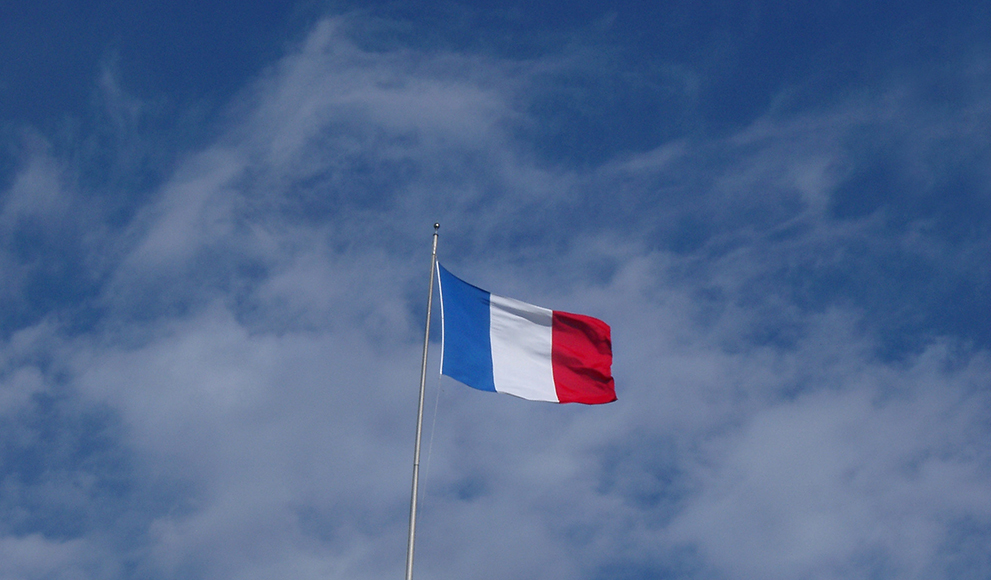 The French flag against blue sky