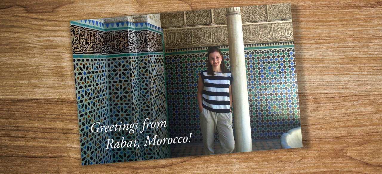 A postcard on a table shows Catherine Puga '17 in Rabat Morocco