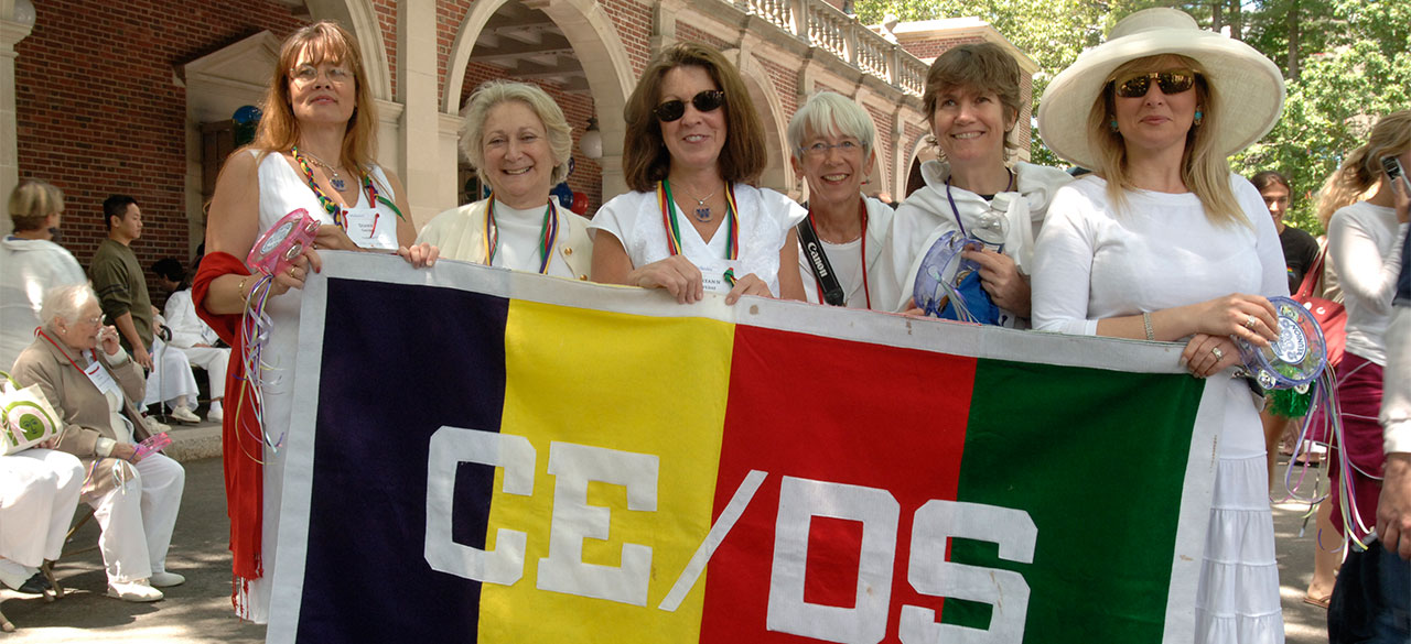 Continuing Education/Davis Scholar Alumnae hold a banner reading CE/DS