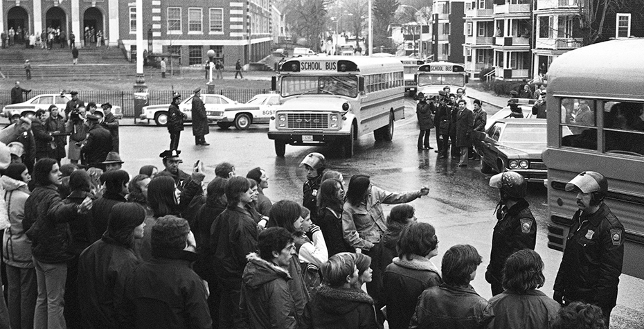 1974 photo: police and crowds outside of schoolbus