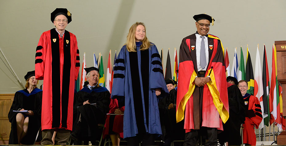 Joe Joyce, Kate Brogan, Chris Arumainayagam on stage in academic robes