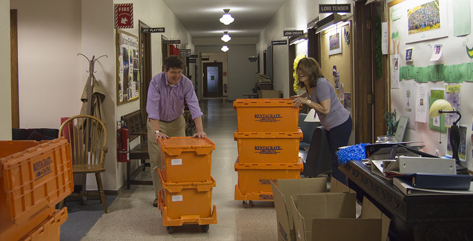 John O'Keefe and Lori Tenser laugh while moving boxes in Green Hall