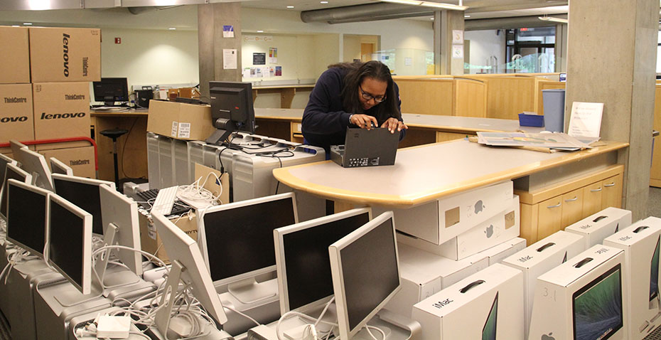 Kanda Faye '15 working on refurbishing retired computers at Wellesley