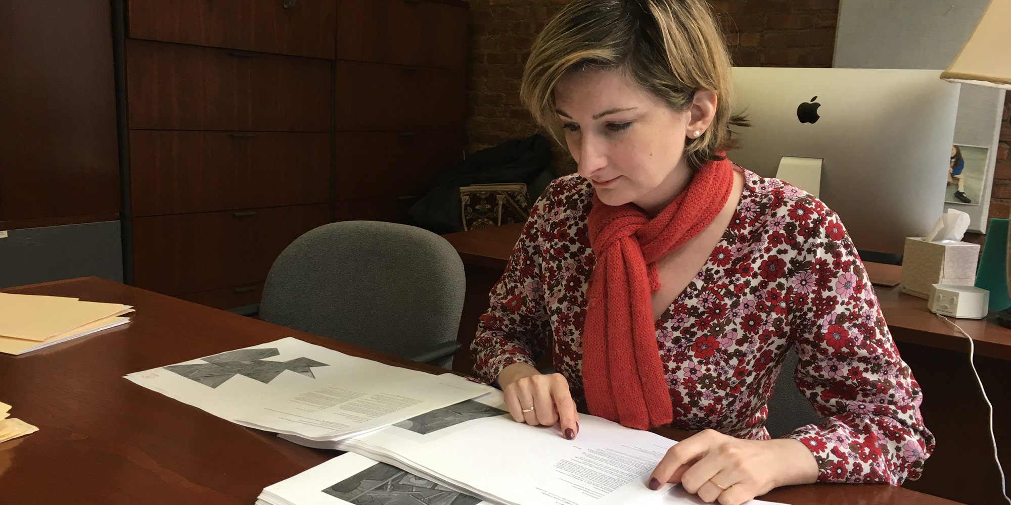 Elizabeth Gorayeb '97 examines papers in her office.