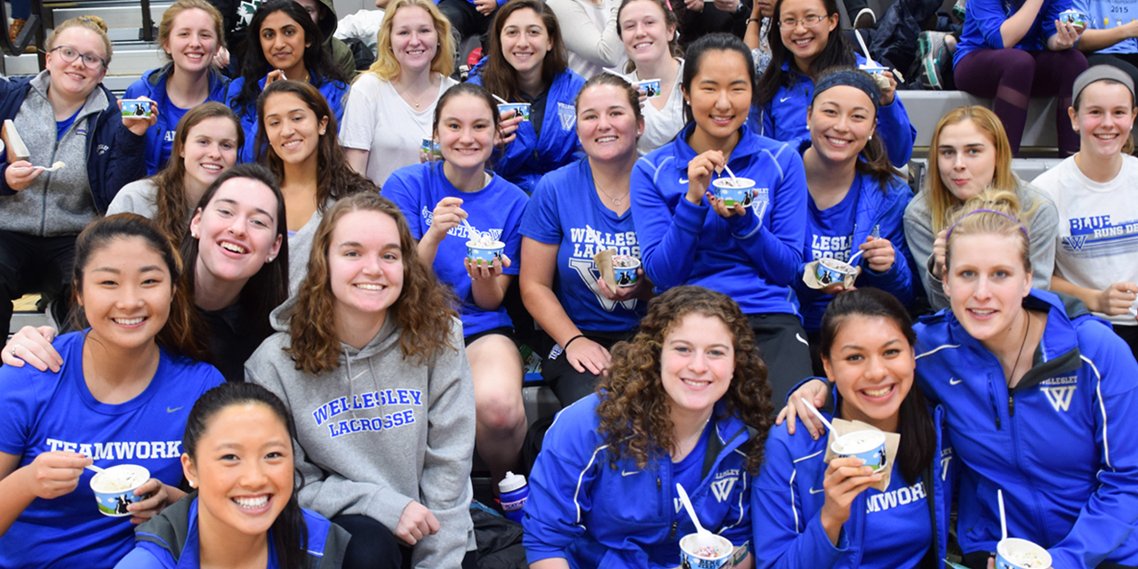 Blue athletes enjoy ice cream during the celebration