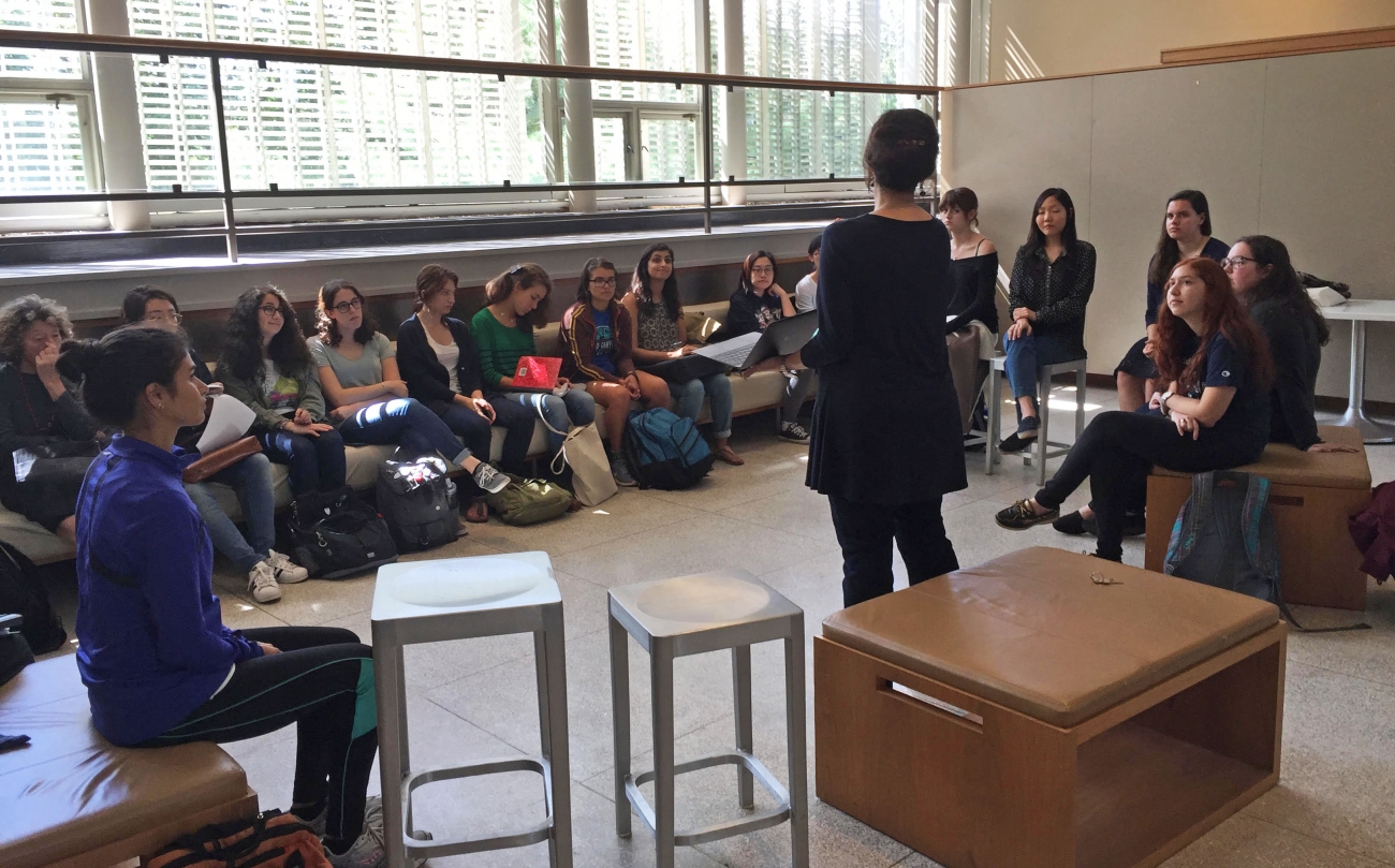 Professor Cassibry speaking to a group of students sitting in the Jewett Sculpture Court