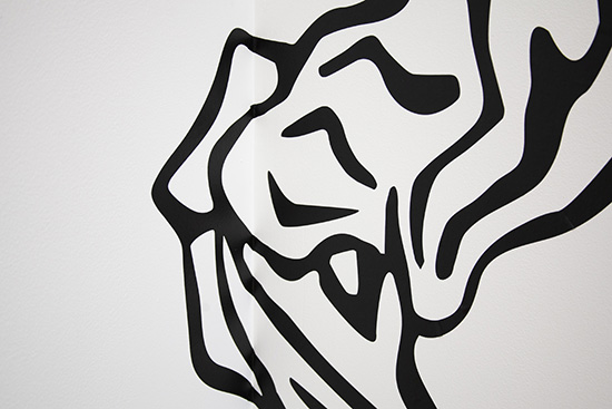 thick black vinyl lines on white wall, barely visible as wrapping around a corner