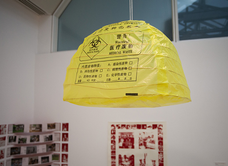 hanging lamp made of yellow plastic medical waste bags, printed with black ink english and chinese text