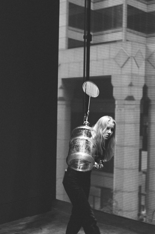 black and white photo of hanging sculpture with patron just behind it