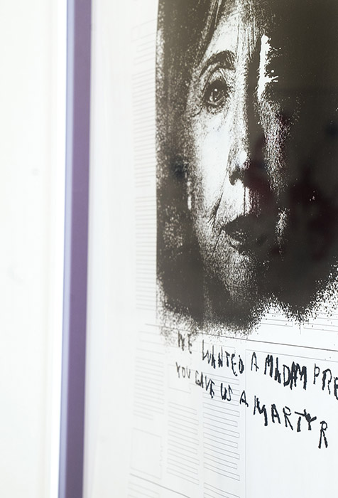 side view of a framed print, showing that there is a purple fabric mounted inside the frame around the print