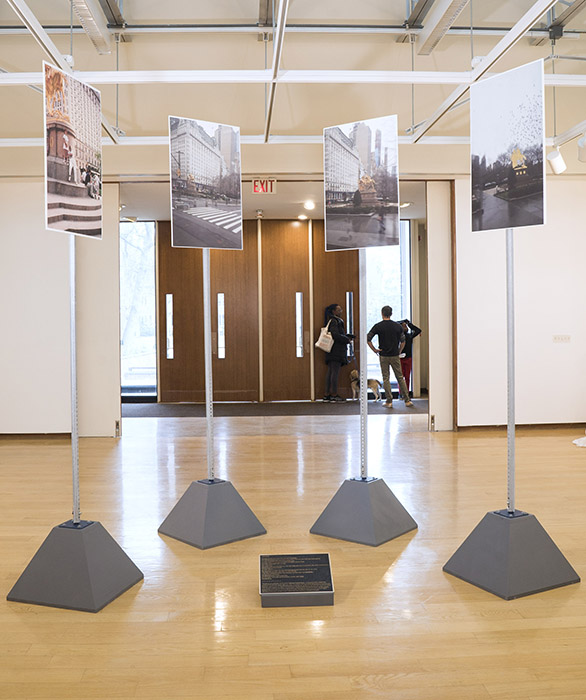 four photos of city monuments on poles with pyramidal gray stands, and a plaque on the ground