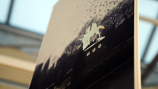 close up on a photo of a monument, with the monument covered in gold leaf