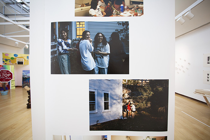 a hanging piece of paper with multiple color photographs printed on it