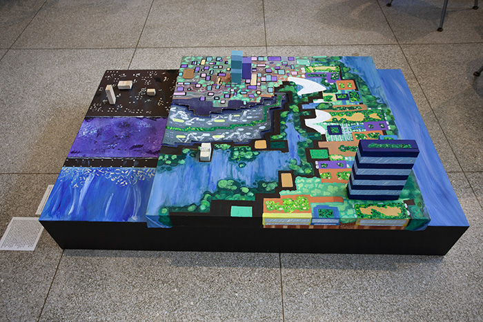 a colorful multi-level sculptural painting, installed on the floor