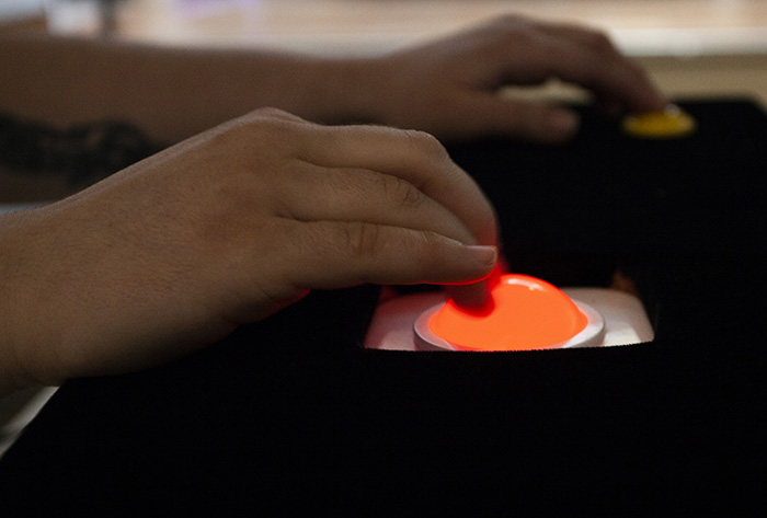 close up on a hand manipulating a glowing red trackball