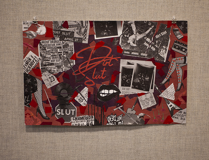 a black, red, and white collage on fabric wall. Text in the center of the collage reads 'Dirt Slut' in a swoopy font.