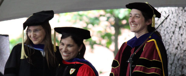 Orit Shaer, Lisa Rodensky, and Tracy Gleason in academic robes on stage