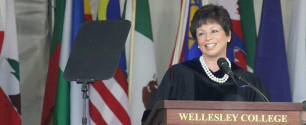 Valerie Jarrett speaks at Wellesley in front of many flags