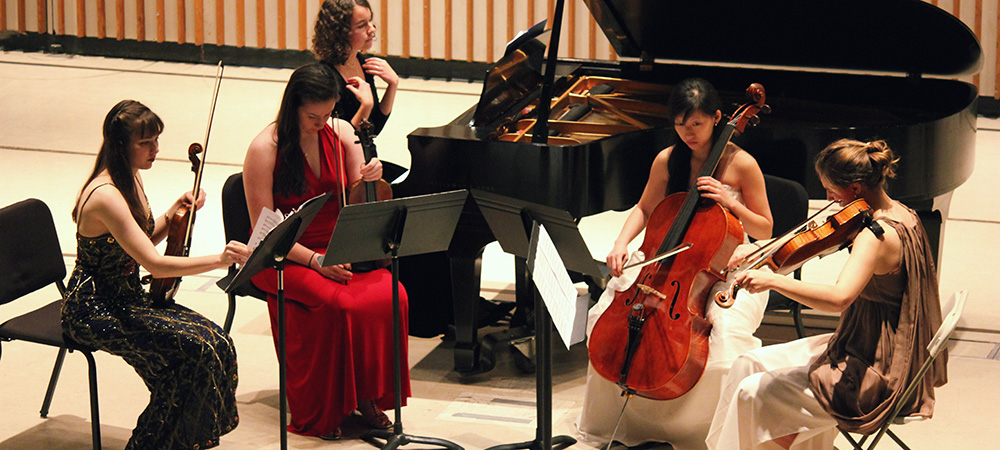 Students preforming in a string quartet 