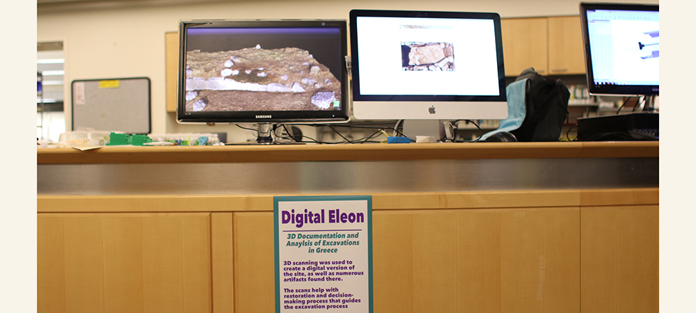 Two computers with 3D scanned archeological artifacts displayed on the screens