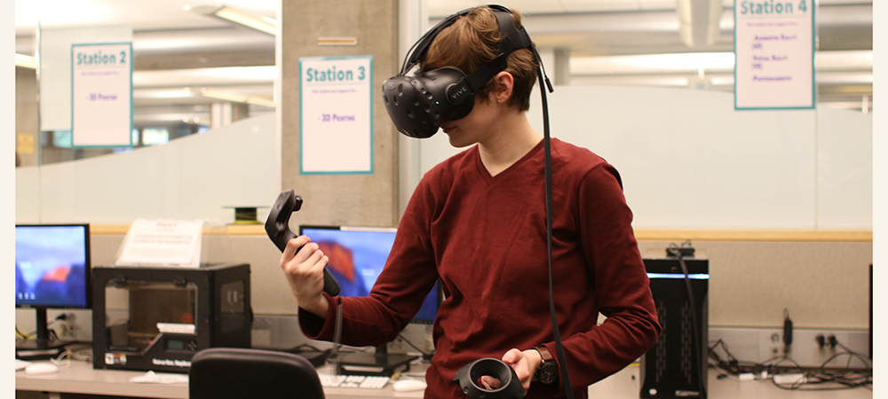 Student standing and wearing a virtual reality headset