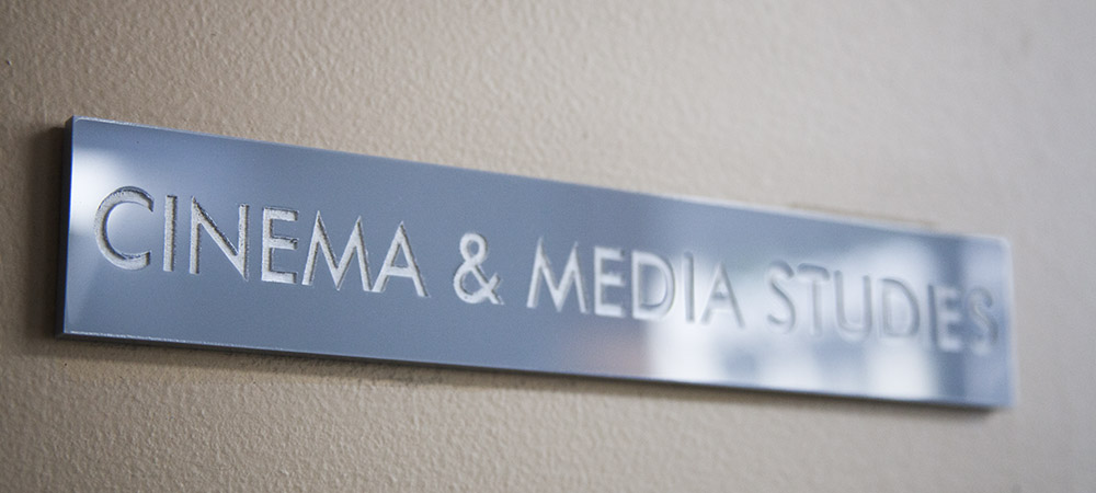 rectangular gray plaque with white text reading CINEMA & MEDIA STUDIES