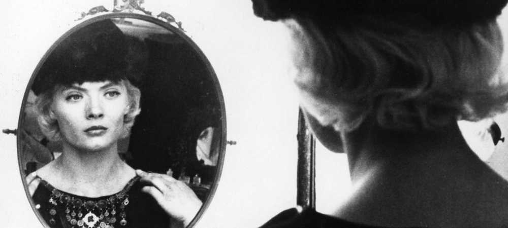 A still from the film Cleo from 5 to 7, A woman stares at herself in the mirror