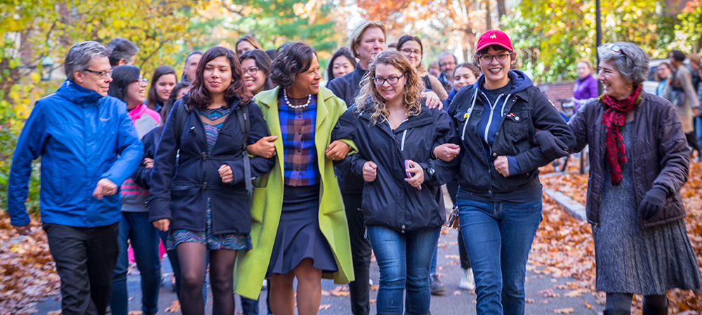 President Paula Johnson walking with students and staff