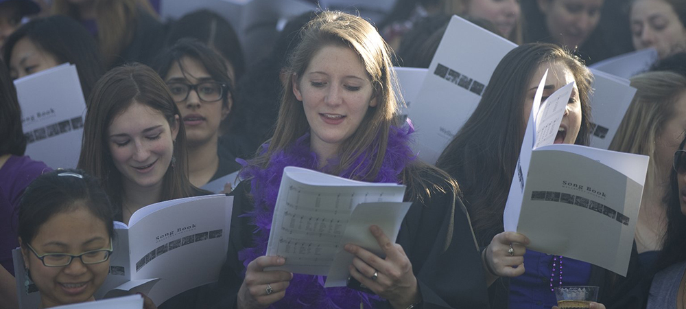 modern day students stepsinging with their song books