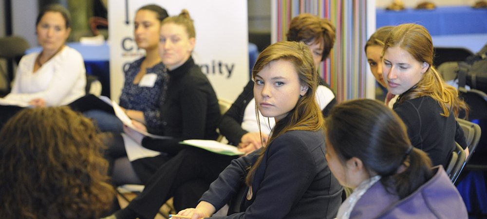 Students listen intently to each other talk about diversity and inclusion 