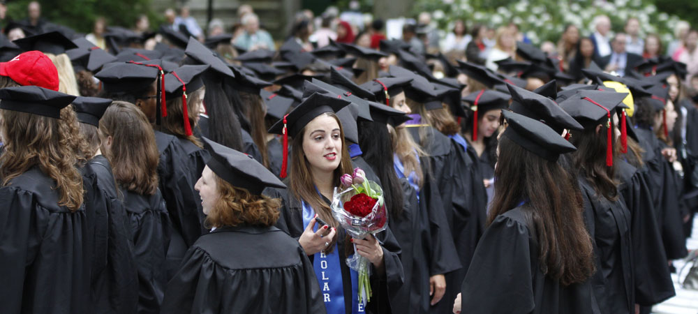 Class of 2012 Student Holds Bouquet of Red Roses at Commencement