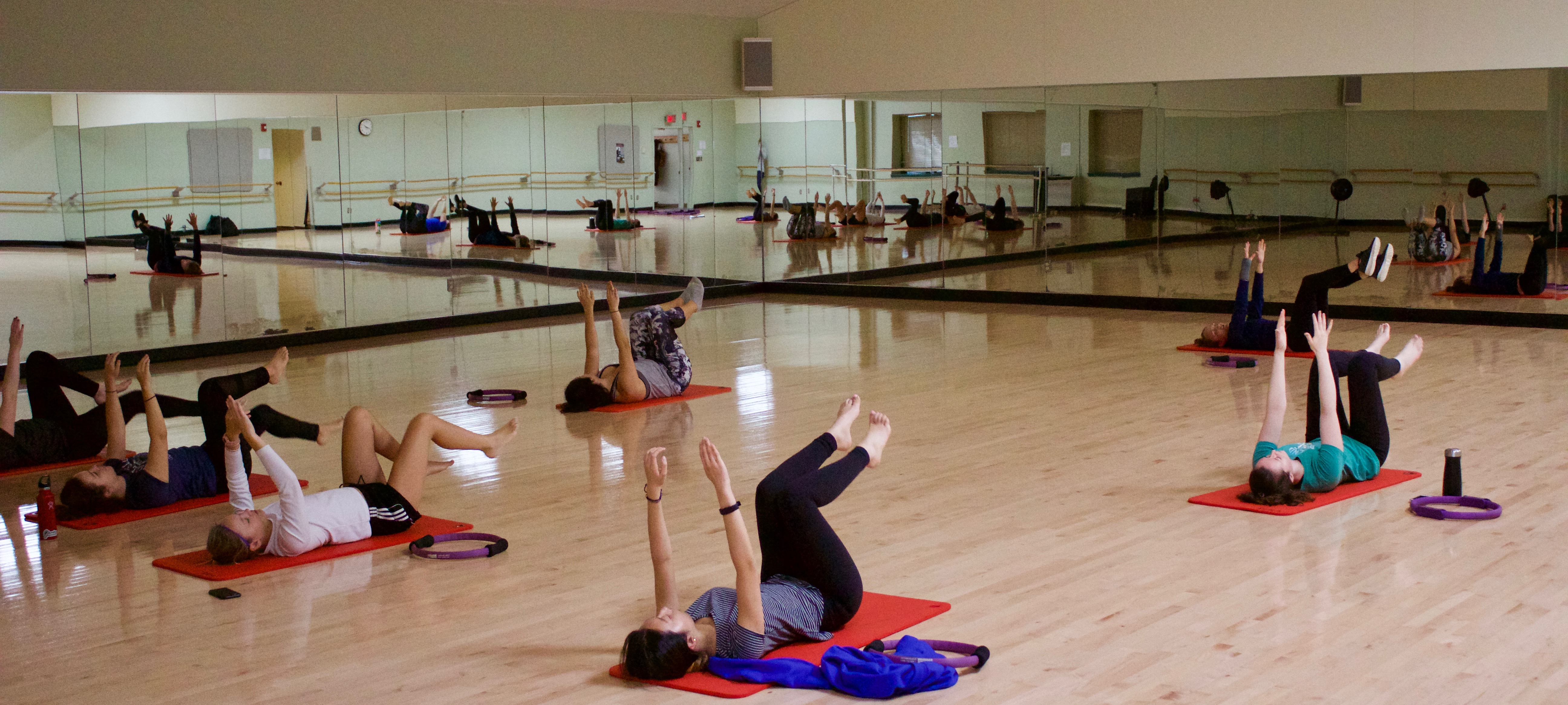 students stretching during a Pilates class