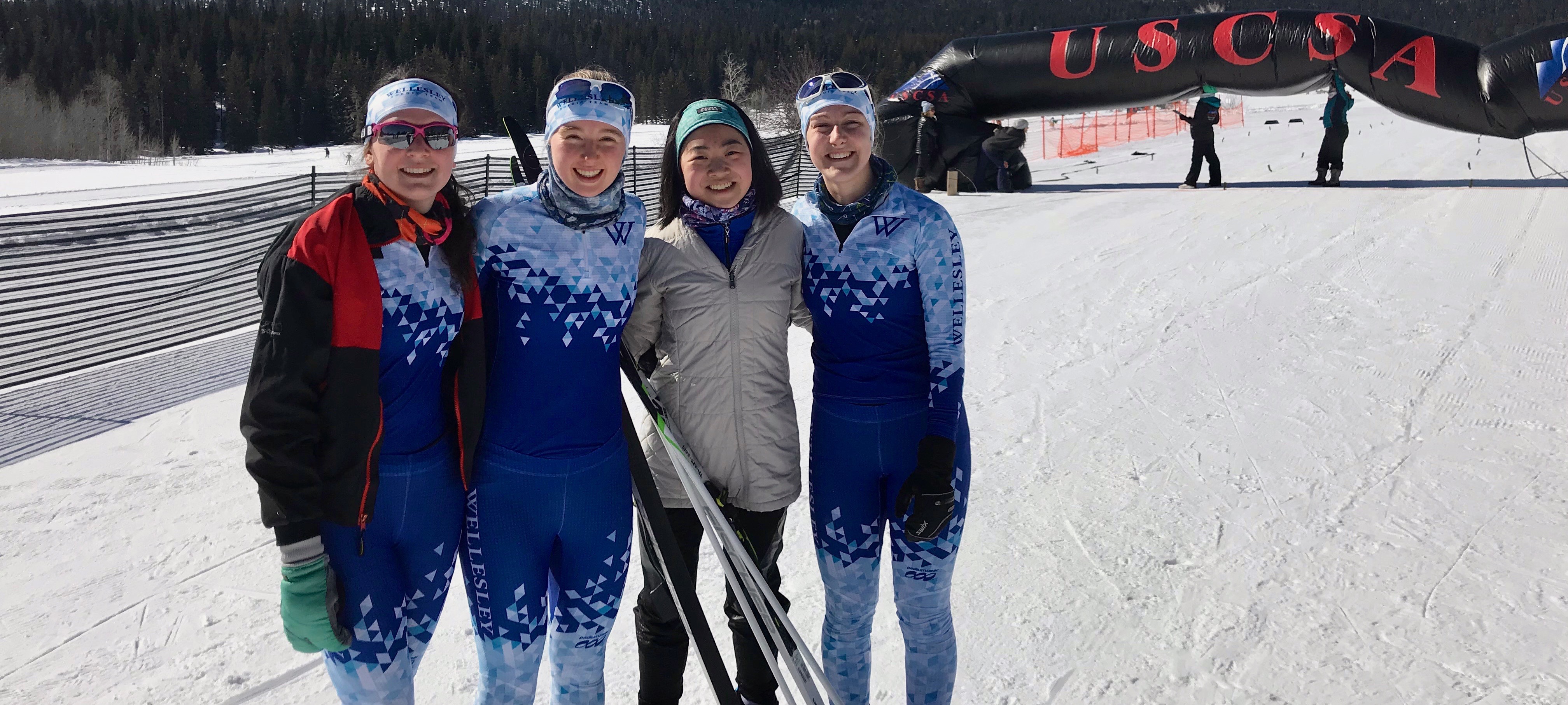 nordic ski team members smiling in the snow