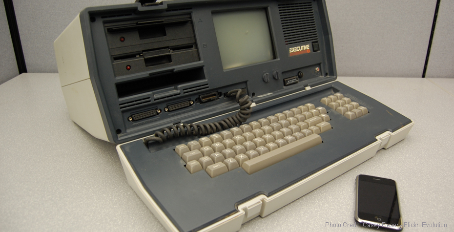 A portable computer from 1982 next to a 2007 Apple iPhone. (Credit: Flickr, Casey Fleser)
