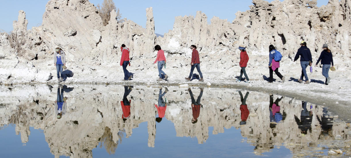 students walking around a lake