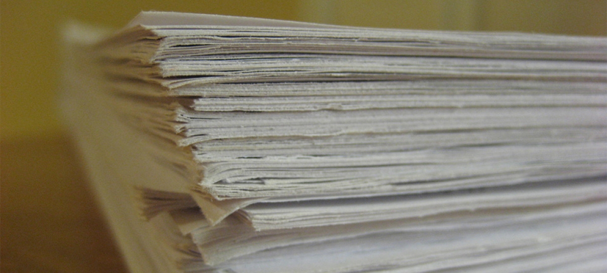 papers stacked on a desk