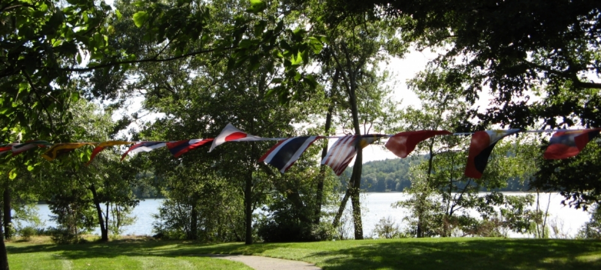 Flags hanging by Lake Waban