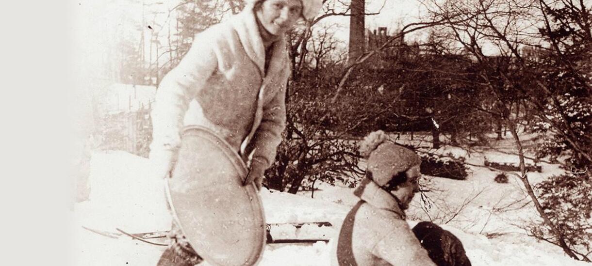 Black and white image of two students traying on Severance Hill in the snow