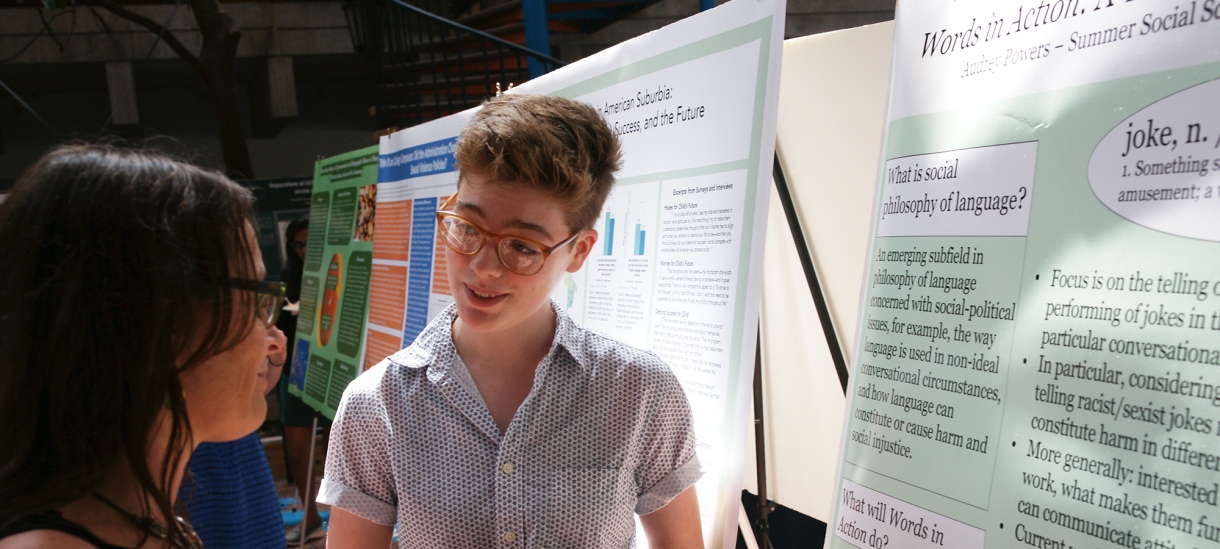 Student gives presentation on research to a member of the college community