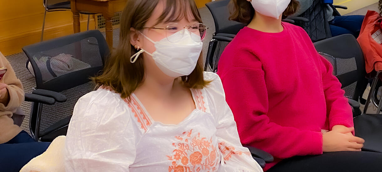 two students sitting at event